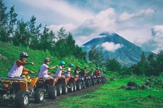 line of people riding ATVs