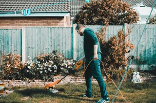 man trimming his grass