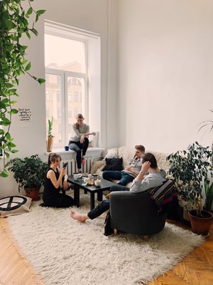 group of people gathered in a living room talking