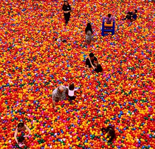 people playing in a huge ball pit