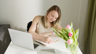 blonde woman sitting at desk planning