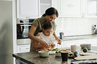 mother with her child making food