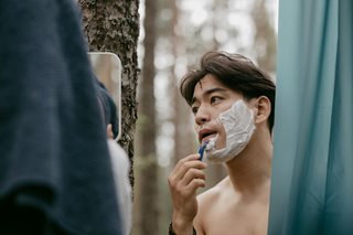 man shaving his face