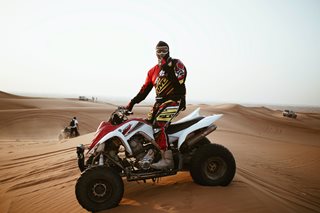 man on ATV in sand dunes