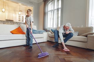 boy and old man cleaning hardwood floors