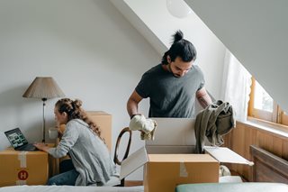 man and woman unpacking boxes