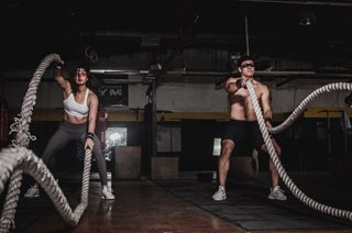 man and woman shaking rope for exercise