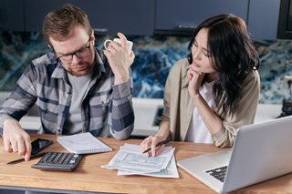 man and woman looking at financial documents