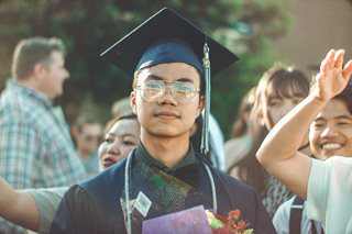 man wearing a graduation cap and gown