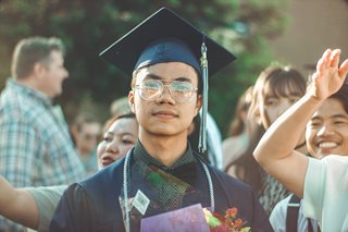 man wearing a graduation cap and gown