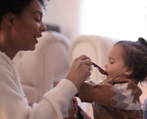 woman feeding her baby