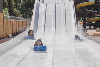 kids riding down a water slide