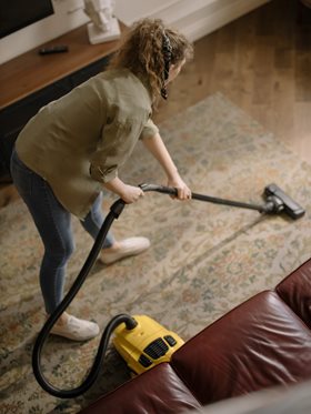 woman vacuuming a rug
