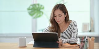 woman in striped shirt on a laptop