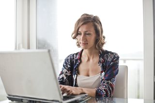 woman typing on a laptop
