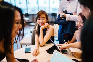 woman sitting with a group of people talking