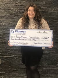 woman holding a giant check
