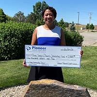 woman holding a large check