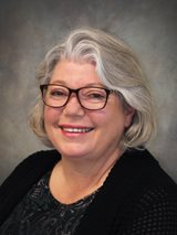 woman with glasses and short gray hair