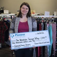 young woman holding a large check