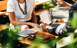 woman and man talking business with a laptop