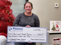 woman holding a  large check
