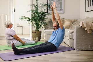 old man and woman doing yoga