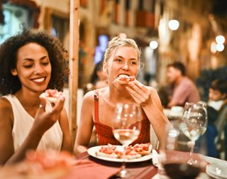 two women eating a fancy dinner