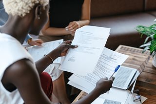 woman holding several papers