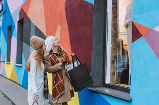 older woman and teenage girl window shopping