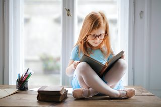 little girl reading a book