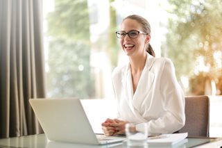 woman laughing with laptop