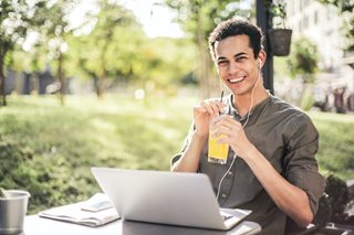 young man with drink and a laptop