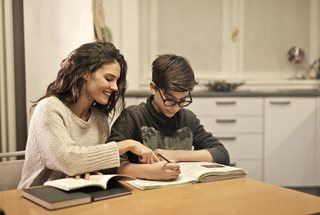 boy and his mother working on homework