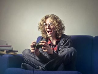 woman sitting on couch playing video games