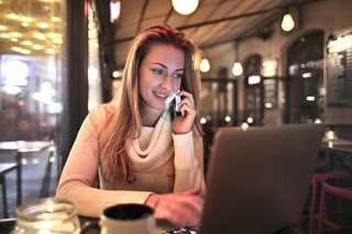 woman on phone and laptop
