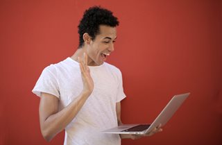 man looking at a laptop happy