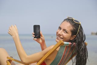 woman sitting on the beach smiling