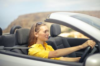woman driving a convertible car
