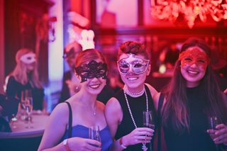 three girls wearing masks