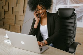 black woman on the phone and a laptop