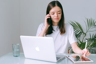 young woman with a tablet and laptop