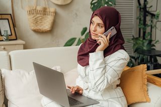 woman in hajib on the phone