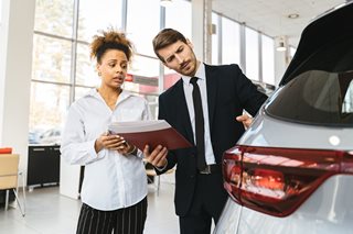 woman and man looking at a new car