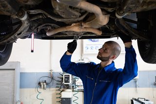 mechanic working under a car
