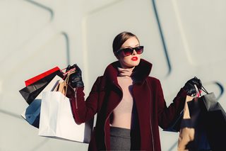 woman with a ton of shopping bag and rich clothing