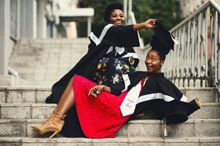 two black women in graduation cap and gown