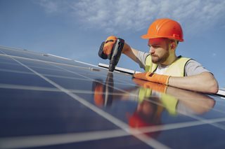 man working on a solar panel