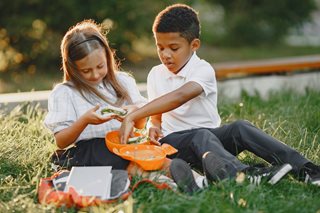 boy and girl sharing picnic food