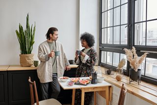 man and woman talking over coffee